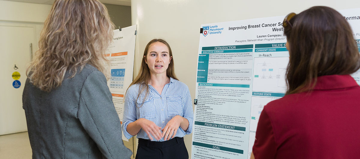 A student presenting a research project board
