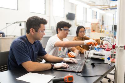 Three Seaver College students working in the Electrical Engineering lab