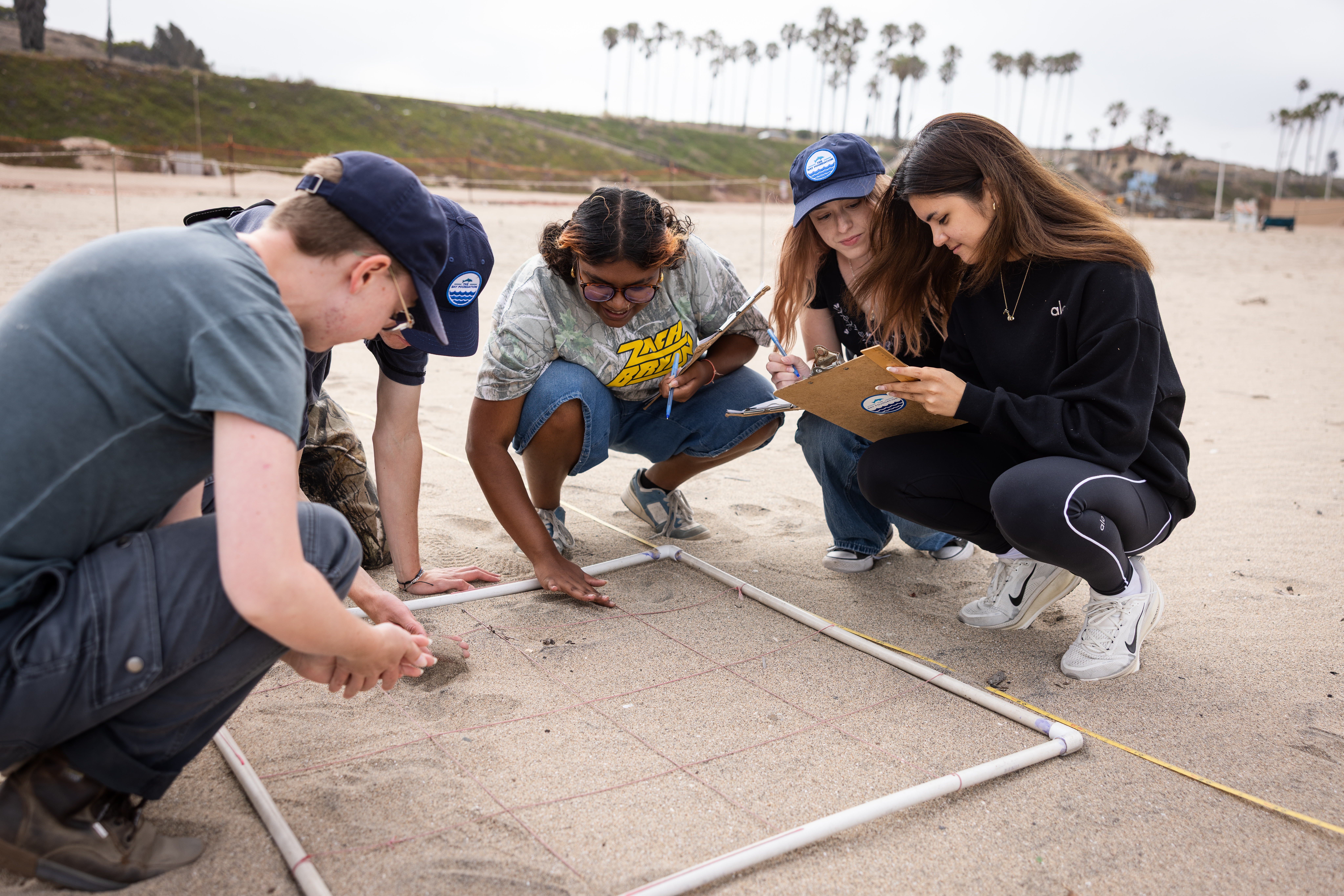 students and mentor analyzing sand
