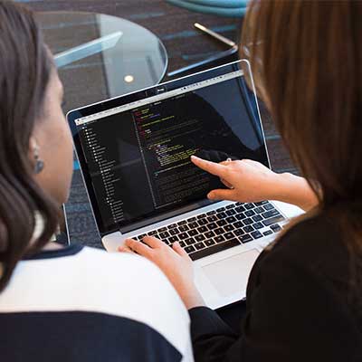 Two male students working on computer code