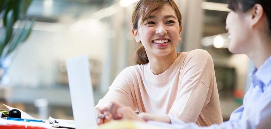 Female student with laptop smiling