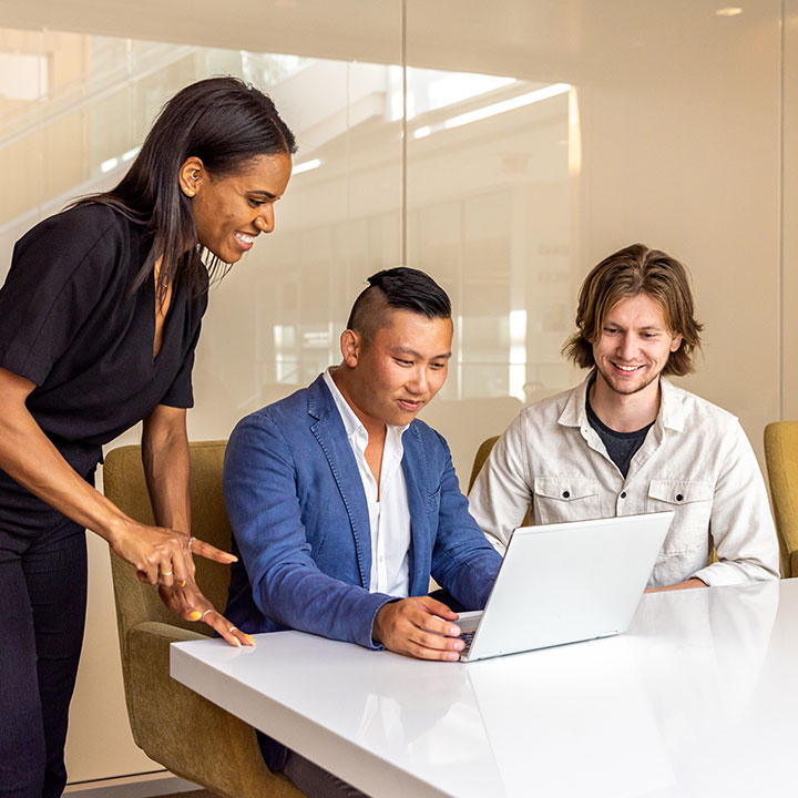 Several students working on a laptop