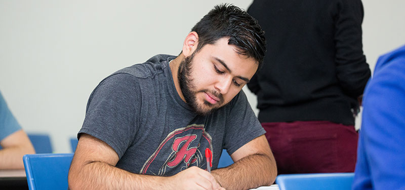 A student taking notes in class