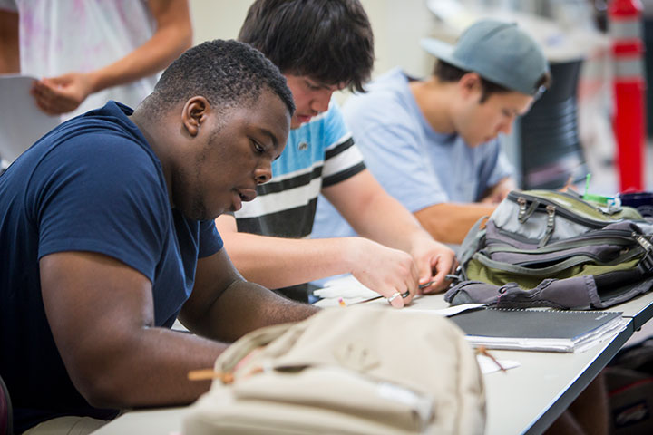 Students taking notes during a lecture