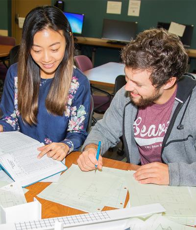 Student and faculty mentor discussing paperwork
