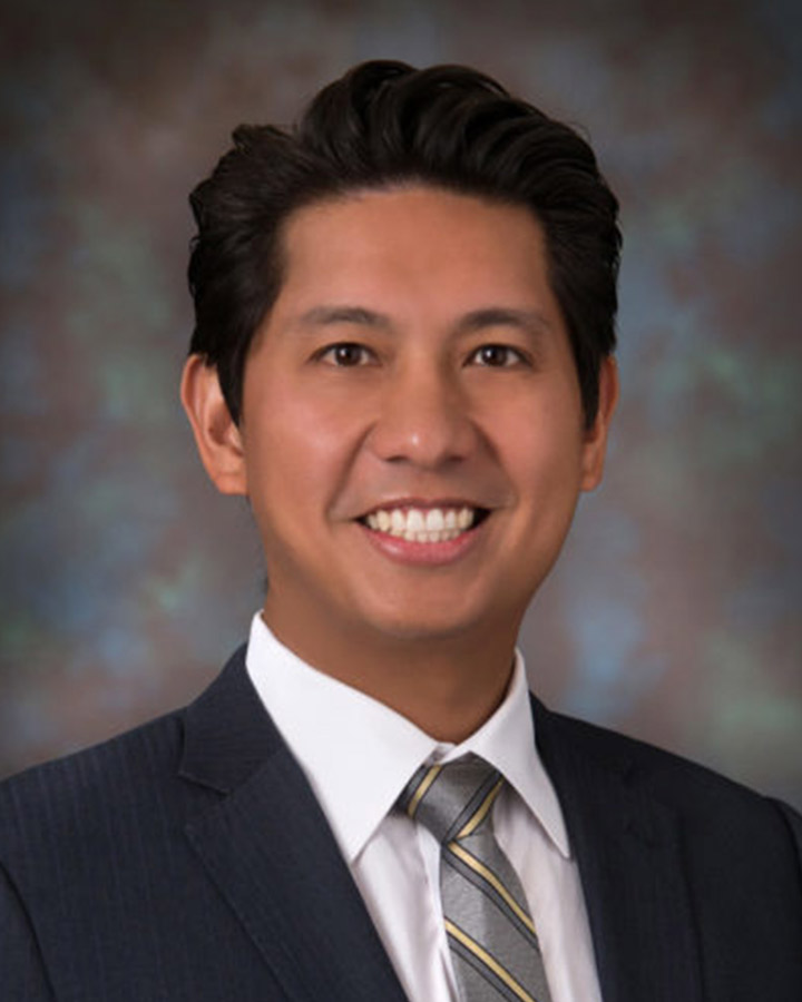 Bryan Calungcagin man in black suit and multicolor background