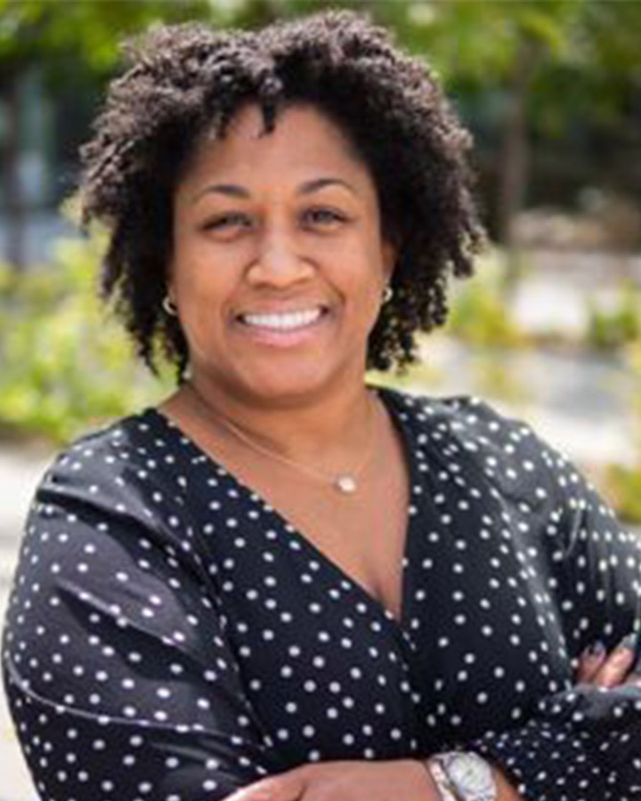 Candace Givens Portrait, woman outside in black and white shirt