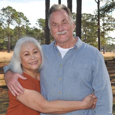 man and woman embracing standing outdoors